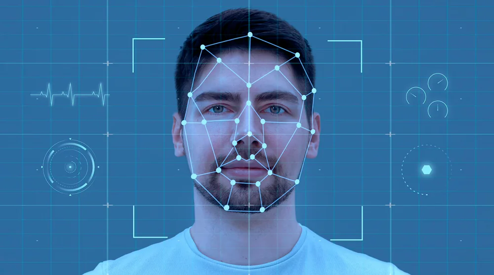 An up close image of a male face with face detection pointers.