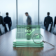 A high-end corporate boardroom with a long wooden table. In the center, a stack of transparent glass tablets glows with green data charts and an upward ROI arrow. A magnifying glass rests against the tablets. In the background, several blurred figures in business suits stand facing a large window overlooking a foggy city skyline.