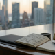 A professional boardroom table at sunset overlooking a city. On the table, an open notebook displays a hand-drawn 