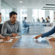 A wide, photorealistic photograph of a modern office meeting where three diverse professionals gather around a large, transparent digital display on a wooden conference table. The glowing, blue and cyan screen shows an abstract, text-free diagram visualizing decision flow and collaboration between automated AI insights and human judgment boundaries. Sunlight streams through a large window, conveying transparency.