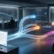 A photorealistic widescreen image of a modern Security Operations Center (SOC) where a single glowing data stream from a computer screen branches out into multiple autonomous pathways, representing the shift from generative AI to complex agentic AI workflows.