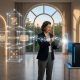A woman standing in a luminous, neoclassical hallway, interacting with glowing holographic data structures representing a 