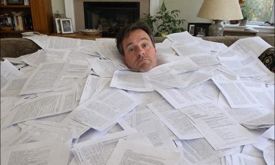 AI-generated image of a man literally up to his neck in printed verbiage. GPT-1.5.