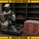 AI-generated article image (GPT Image 2): an industrial humanoid robot sits with its feet raised, reading Popular Mechanics beside a turntable playing a record and a partially filled metal record rack. A cat sleeps on otherwise empty shelving behind it. A yellow-and-black border reads ‘AI FANTASY INSIDE’ and ‘REALITY OUTSIDE’.