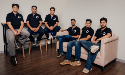 Six members of the Dodge AI team wearing black Dodge shirts in an office
