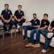 Six members of the Dodge AI team wearing black Dodge shirts in an office