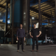 Forgepoint co-founders standing inside a manufacturing facility with industrial equipment and a forklift.