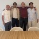 Evos founder and CEO Urav Shah with the company’s first three employees during an onsite visit.