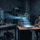 An engineer explains her work at a workshop bench while threads of blue light carry her words into a glass machine that stacks pages, which an editor reviews under a warm desk lamp.