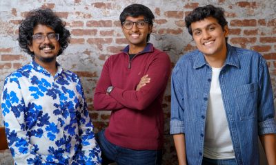 Three members of Clueso’s founding team standing together in front of a brick wall.
