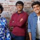 Three members of Clueso’s founding team standing together in front of a brick wall.