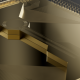 Close-up rendering of Quantinuum’s gold Helios ion-trap chip against a dark background