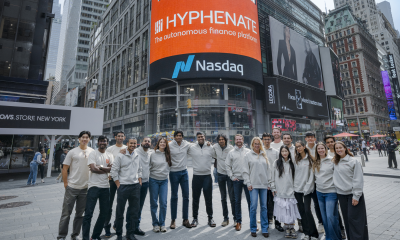 Hyphenate team in Times Square beneath the Hyphenate Nasdaq display.