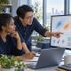 Data scientists comparing machine learning experiments and model evaluation charts