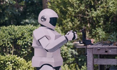 An AI-extended screenshot from the 2012 sci-fi outing 'Robot and Frank', here showing Robot practicing how to pick a lock. Image adapted to format and refined by GPT Image 2 and Photoshop. Still from Robot & Frank (2012). © 2012 Hallowell House, LLC. All Rights Reserved. Used strictly for illustrative and cultural purposes.