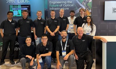 Twelve members of the Salience Labs team at their optical switching exhibition booth at ECOC 2026.