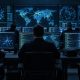 Unnamed operators at banks of monitors showing network maps and code in a dim operations room